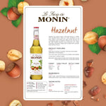 Monin Hazelnut Syrup 700ml bottle, ideal for coffee and desserts, featuring a clear label and dark amber liquid inside.