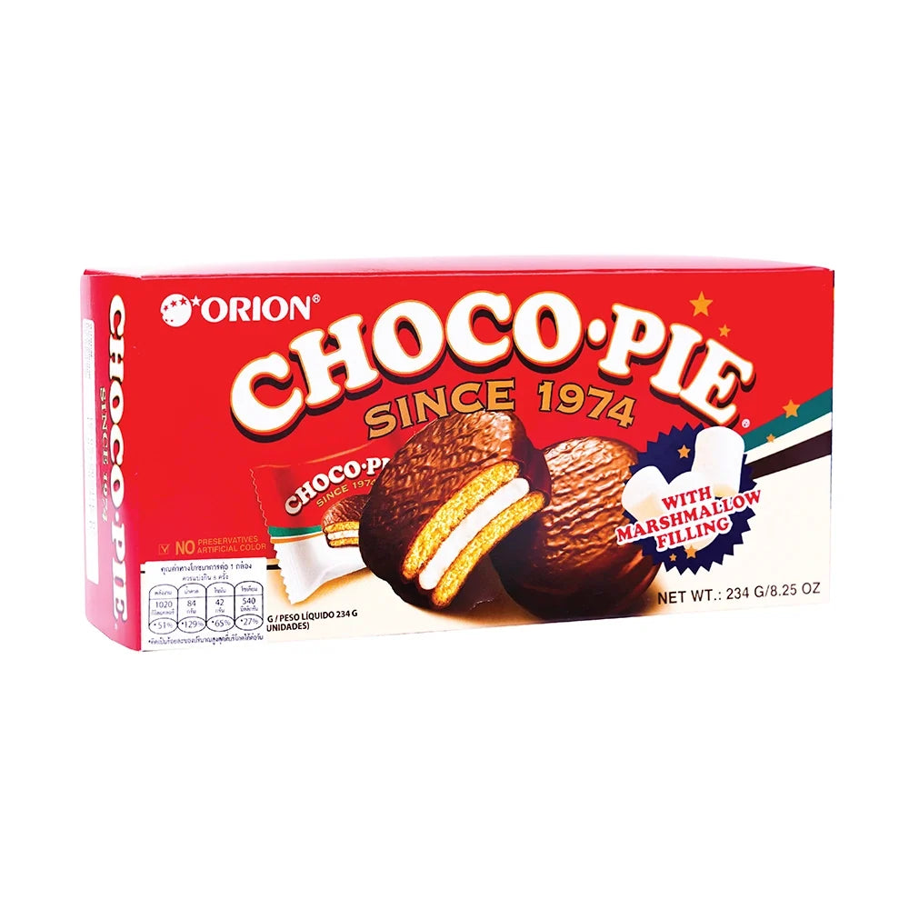 Orion Chocopie snack with marshmallow filling and chocolate coating, displayed on a plate with some pieces cut open.