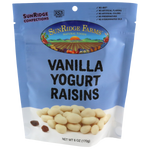 Sunridge Farms All Natural Yogurt Raisins in a clear bowl, showing plump, golden raisins coated with creamy yogurt.