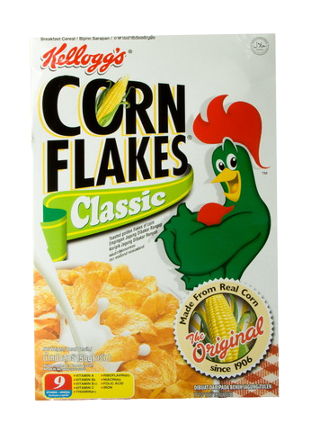 Bowl of Kellogg's Cornflakes cereal in a white bowl with milk, showing golden flakes and a spoon on a white background.