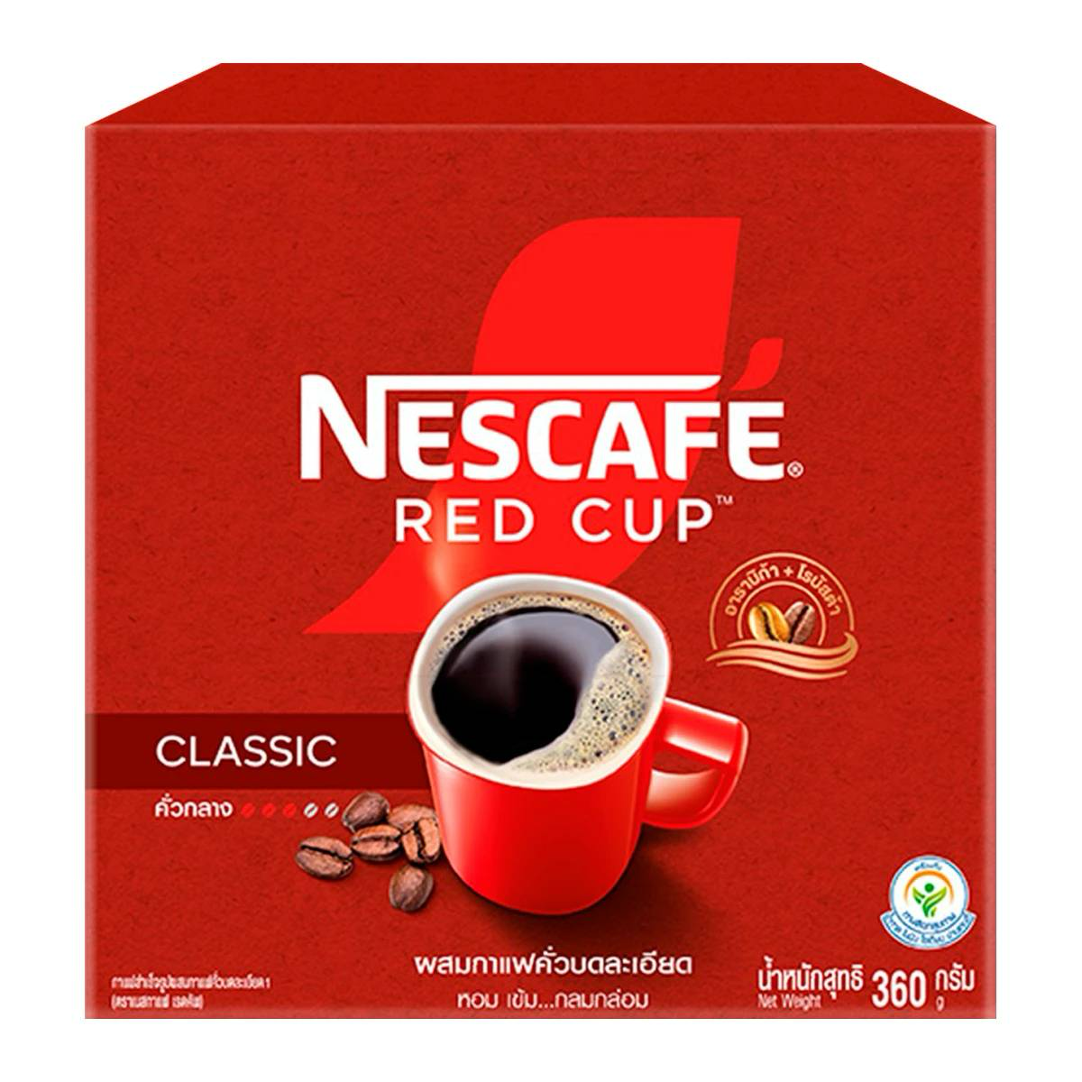 A steaming cup of Nescafe Red Cup coffee on a saucer, showcasing the iconic red branding and rich, dark coffee inside.