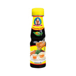 Deksomboon Seasoning Sauce 150ml bottle, visible label, used for flavoring in cooking, in a dry grocery setting