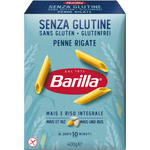 A close-up of gluten-free Barilla Penne pasta in a clear glass bowl, showcasing the golden pasta tubes ready for cooking.