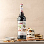 Bottle of MONIN Tiramisu Syrup in 700ml size, used for enhancing coffee and dessert flavors in dry grocery products.