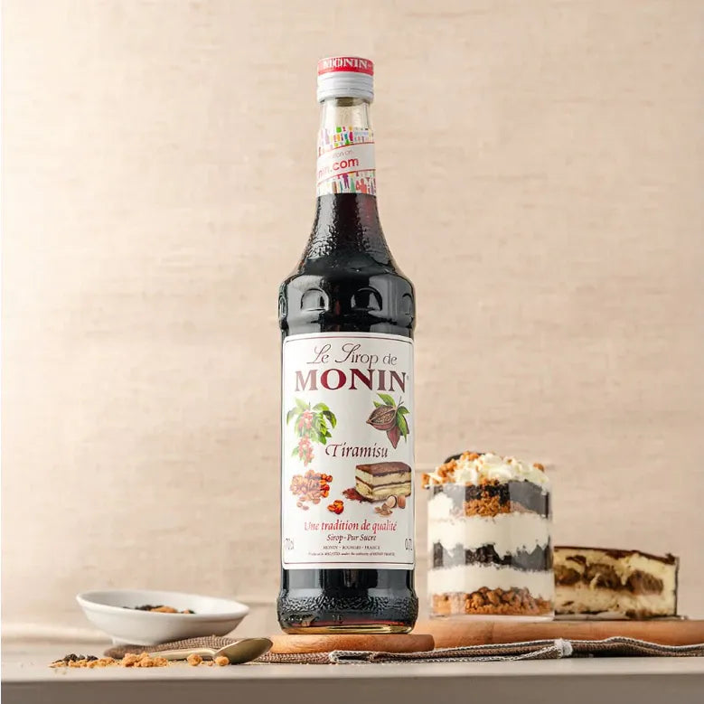 Bottle of MONIN Tiramisu Syrup in 700ml size, used for enhancing coffee and dessert flavors in dry grocery products.